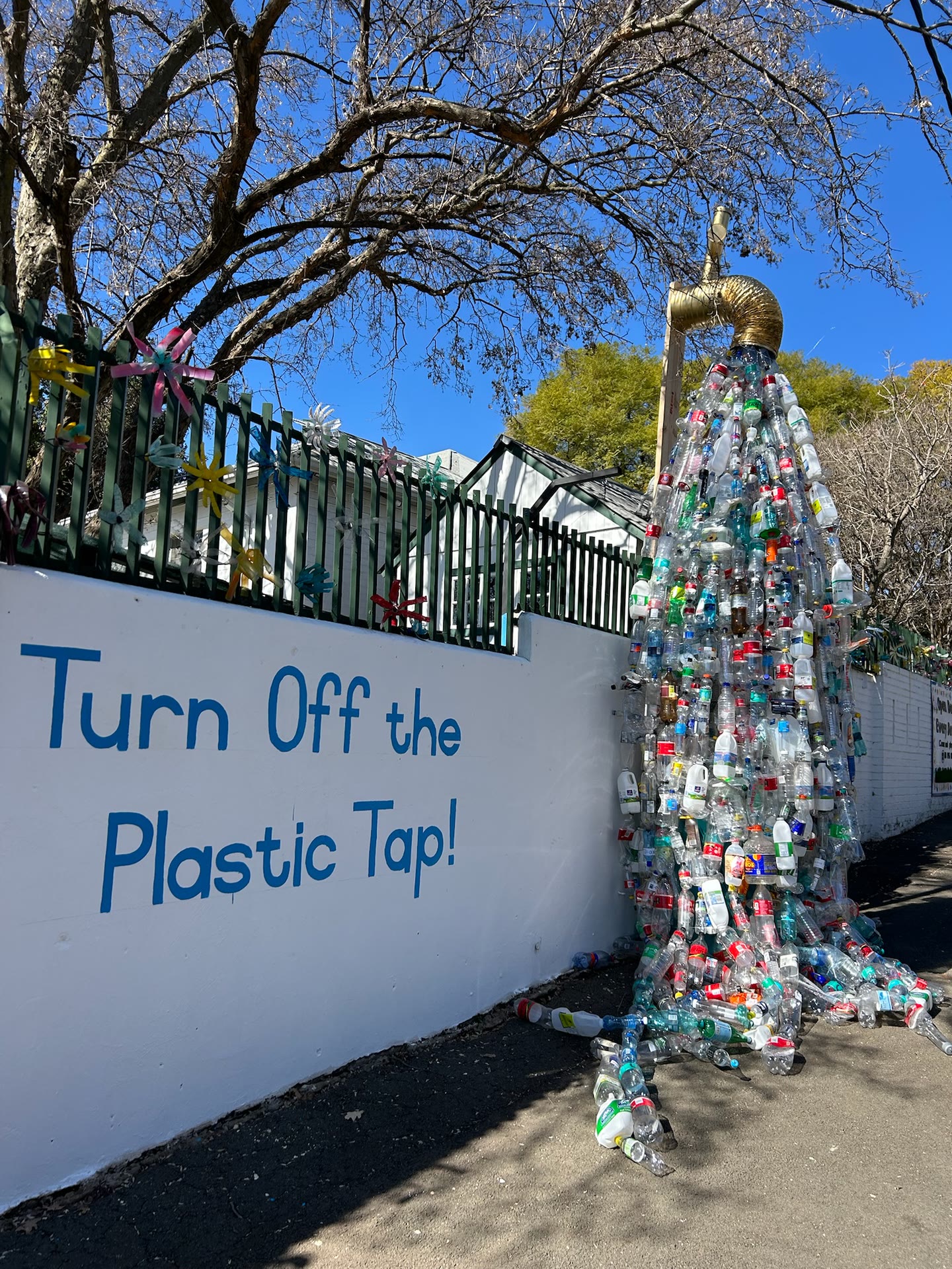 Turn Off the Plastic Tap mural, with a tall sculpture made from collected plastic bottles