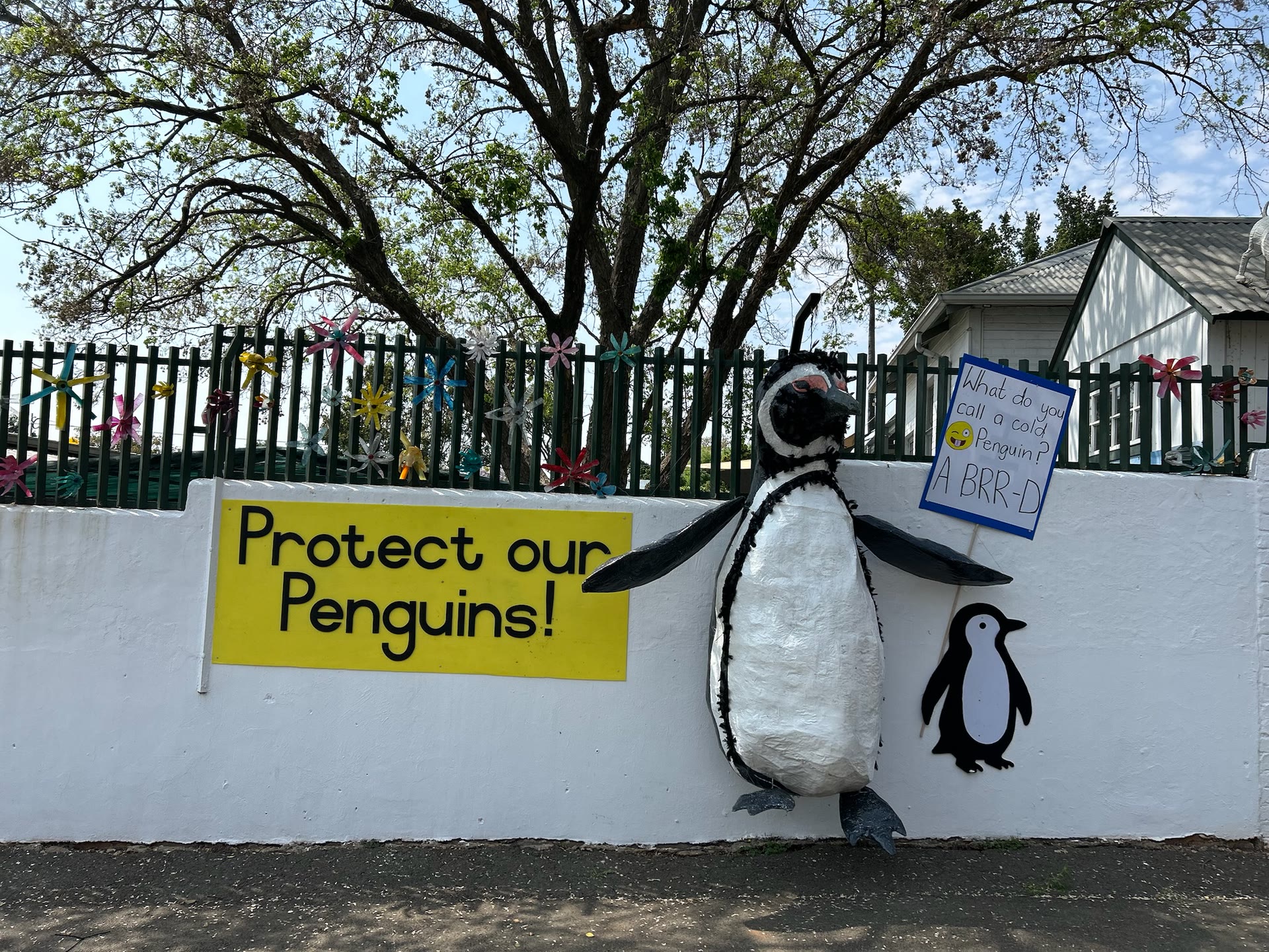 Protect our Penguins mural, with a penguin sculpture made by the children
